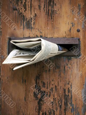 Wooden mailbox with newspaper