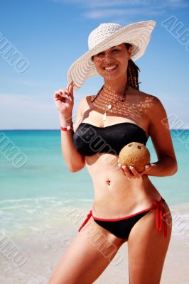 girl with hat in paradise by the sea