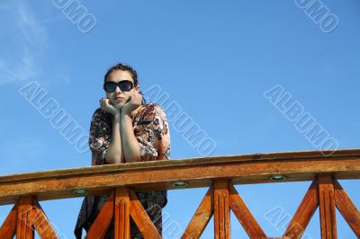 woman standing on the bridge and thinks