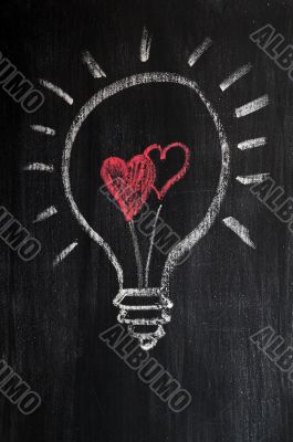 Lightbulb drawn with chalk on a chalkboard symbolizing love
