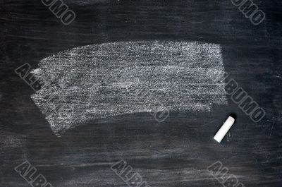 Smudged blackboard background with chalk and copy space