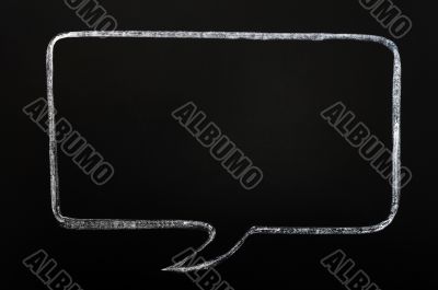 Blank speech bubble drawn on a smudged blackboard