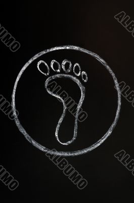 Chalk drawing of footprint symbol on blackboard background