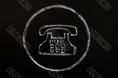 Old phone symbol drawn with chalk on blackboard background