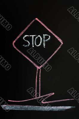 Stop warning sign drawn on a blackboard background