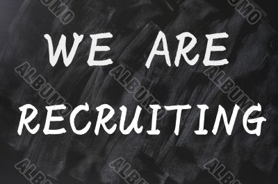 Concept of we are recruiting written on smudged blackboard background