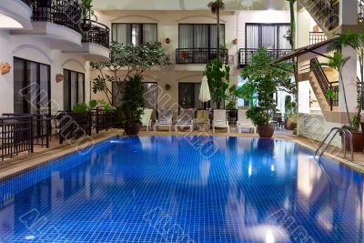pool with blue water in a cozy hotel