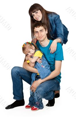 father, mother and young daughter in jeans