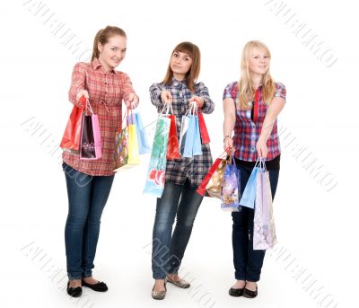 Three girls with colorful shopping bags