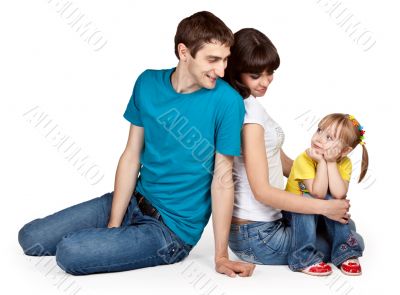 father, mother and young daughter in jeans