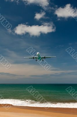 plane over a tropical beach