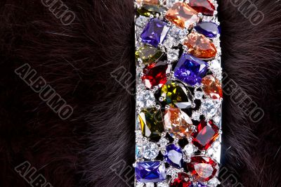 bracelet with precious stones in a dark fur