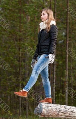 A beautiful girl goes to log