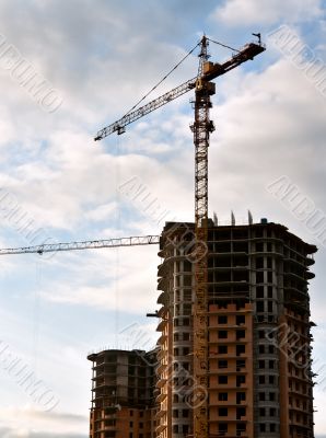 Stand, house, construction crane in the sky with clouds