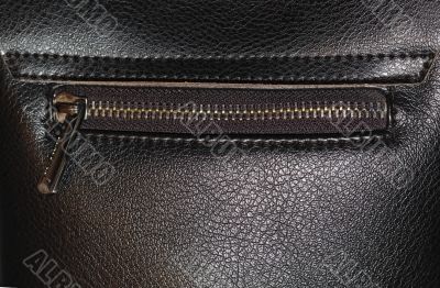 Zipper on dark brown leather hand bag