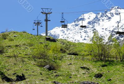 Empty cableway and caucasus mountains background