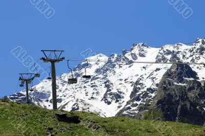Empty cableway and caucasus mountains background