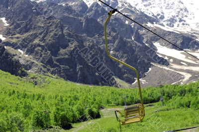 Empty cableway and caucasus mountains background