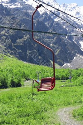 Empty cableway and caucasus mountains background