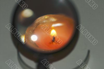 magnifying glass, a candle