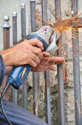 Worker hands with grinder