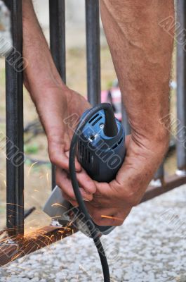 Worker hands with grinder