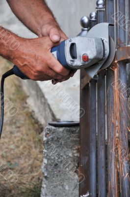 Worker hands with grinder