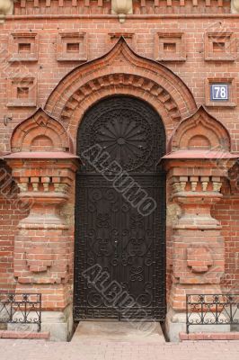wall of red brick and black front door