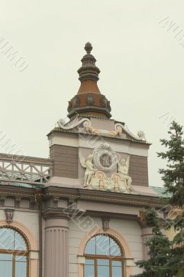 The facade of the building with a sculpture