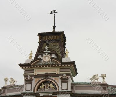 The facade of the building with a sculpture