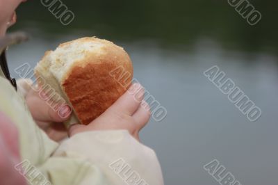 child taking a piece of bread