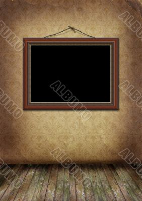 frame hangs on an old wall. 