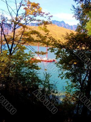 Red Boat Viewed Through Trees