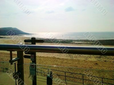 Rail, Beach And Sign Post