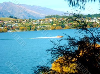 Speedboat On Lake By Houses