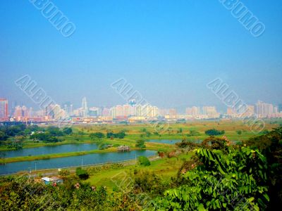 Lakes With City Skyline In Background