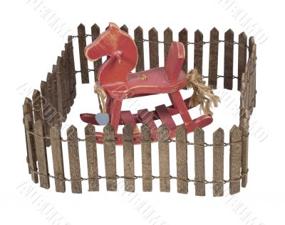Rocking Horse Enclosed in Picket Fence