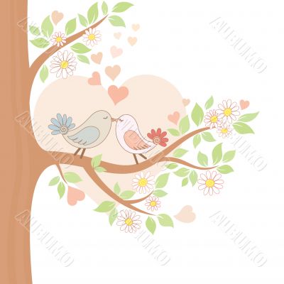 Two kissing birds on the tree
