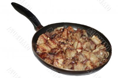 Fried meat cooking in the pan isolated