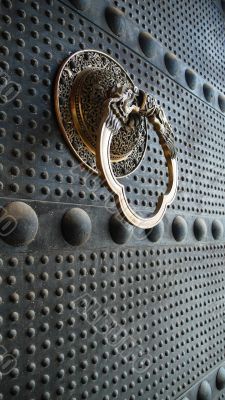 Ancient iron door with a copper doorknob