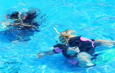 Scuba divers in blue water
