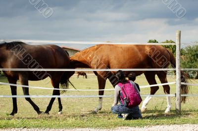Mother and child in front of a horse gate