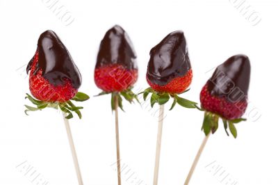 four strawberries with melted chocolate