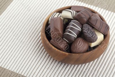 assorted chocolate in wooden bowl