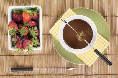 melted chocolate in bowl with strawberries