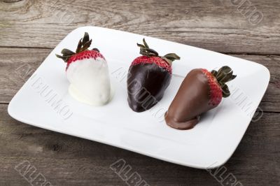  coated strawberries on a white plate