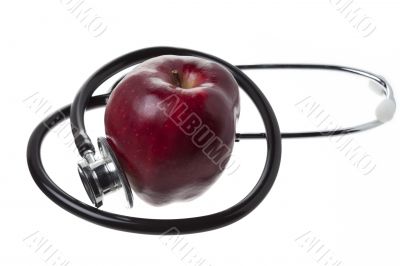 apple and stethoscope on white background
