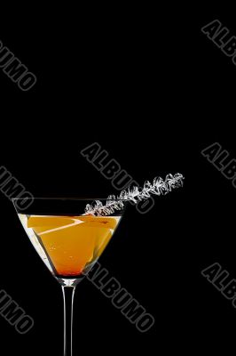close up shot of orange drink in martini glass