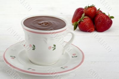 cup of hot chocolate and strawberries