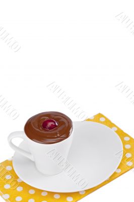 cup of melted chocolate on a plate  with cherry